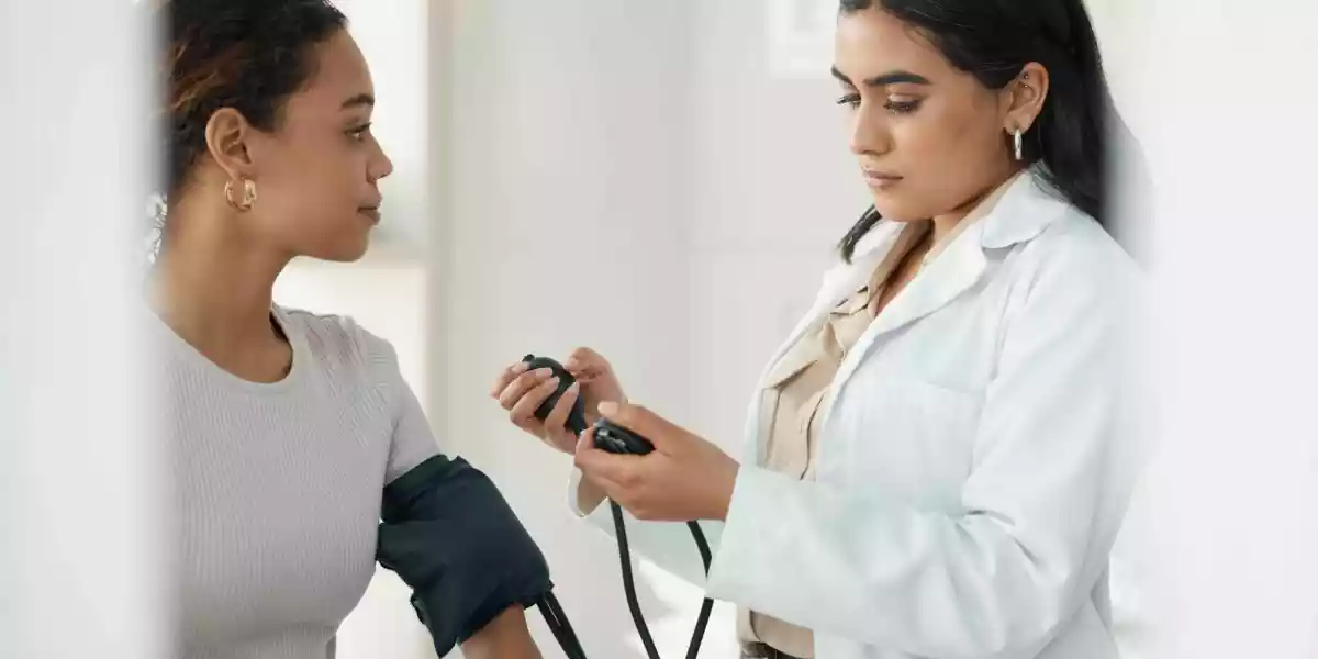 Woman at a health center taking blood pressure