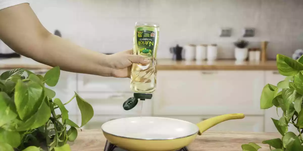 Nutrioli Non Drip Pure Soybean Oil bottle neatly pouring into the pan