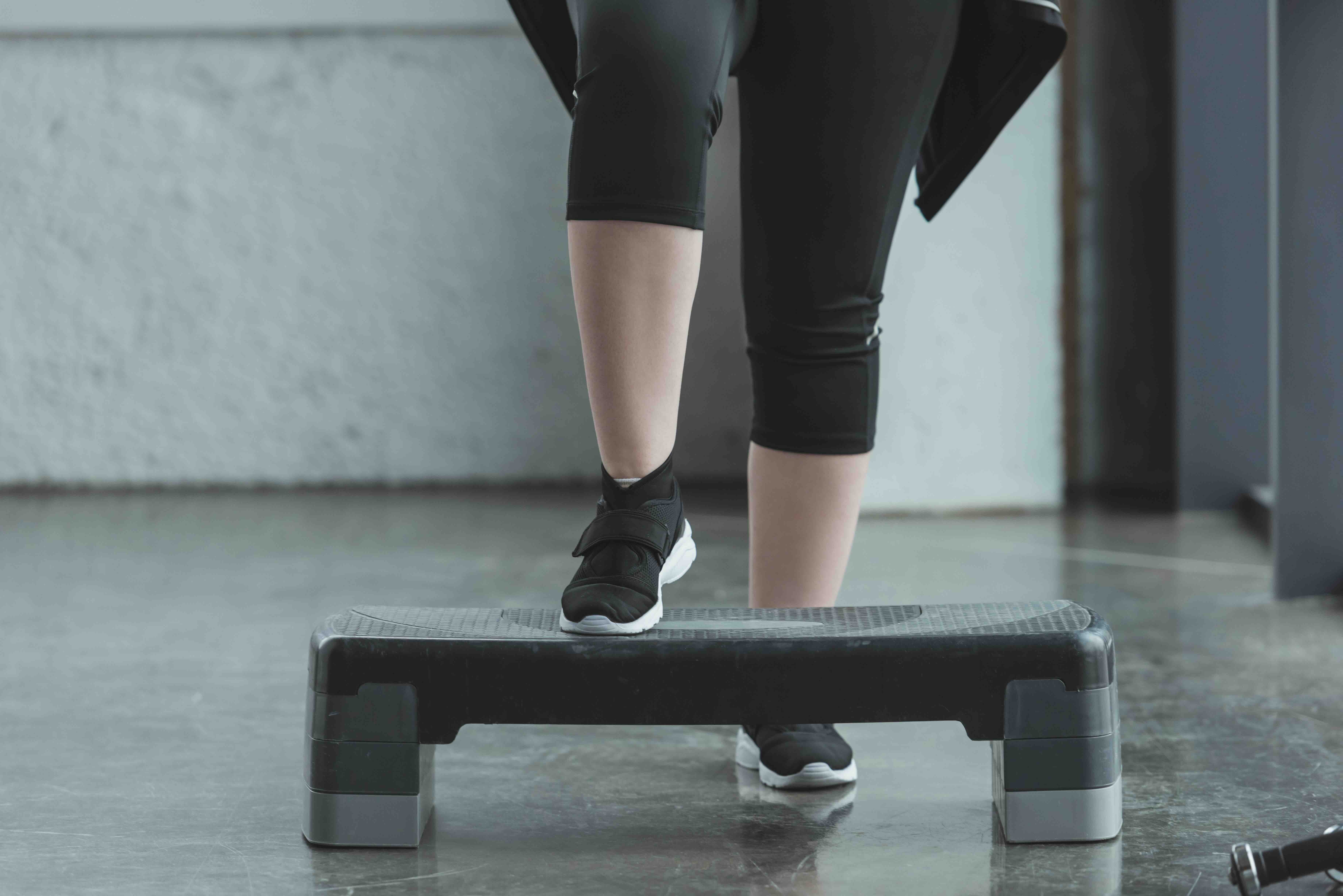 woman doing a step exercise with a stepper